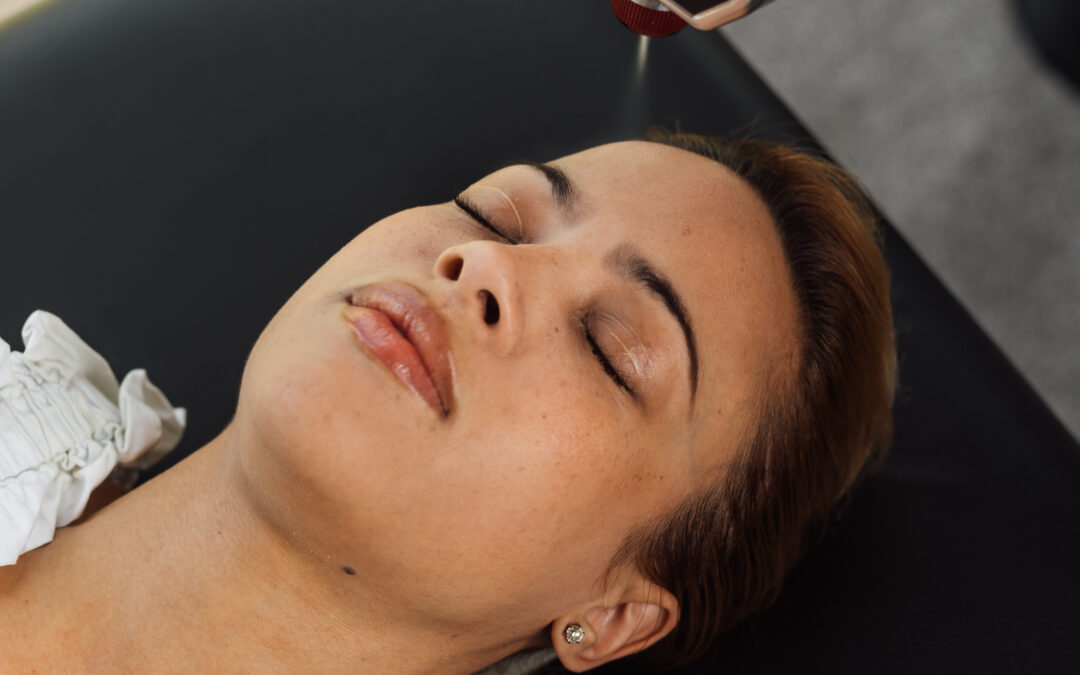 A cryo facial treatment is applied on a woman's face.